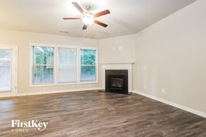 Mcdonough house for rent - a living room with a fireplace and a ceiling fan