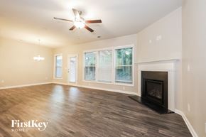 Mcdonough house for rent - a living room with a fireplace and a ceiling fan