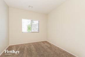 Tucson house for rent - a bedroom with carpet and a window