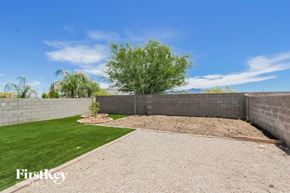 Tucson house for rent - a garden with a gravel pathway and grass in a retaining wall
