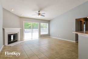 Jacksonville house for rent - A spacious living room with a fireplace and sliding glass doors.