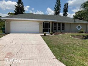 Port Charlotte house for rent - a house with a driveway and a garage door