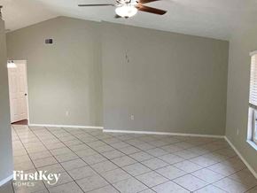 Port Charlotte house for rent - an empty living room with a ceiling fan