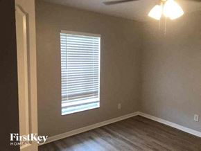 Cape Coral house for rent - a living room with a window and wooden floors