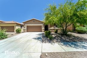 Tucson house for rent - a house with a driveway and a tree in front of it