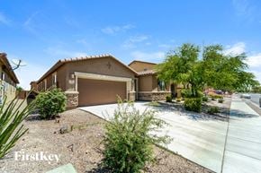 Tucson house for rent - a house with a driveway and a garage door