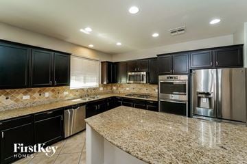 Tucson house for rent - a kitchen with granite counter tops and stainless steel appliances