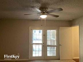 Euless house for rent - a bedroom with a ceiling fan and a window