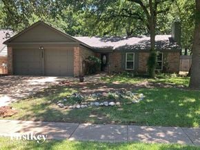 Euless house for rent - a house with a yard with rocks in front of it