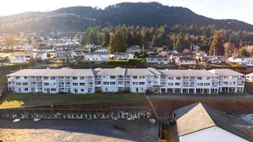 Ladysmith apartment for rent - A large white building with a green lawn in front of it.