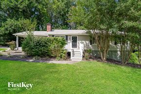 Lewisville house for rent - A house with a front yard and a tree in the front.
