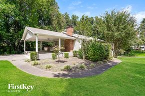 Lewisville house for rent - A house with a white porch and a green lawn in front.