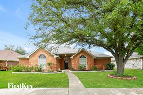 Garland house for rent - a brick house with a tree in front of it