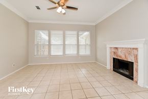 Garland house for rent - a living room with a fireplace and a tiled floor