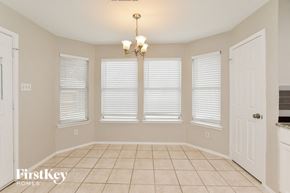 Garland house for rent - a dining room with three windows and a tiled floor