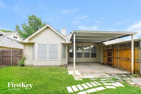 Garland house for rent - a small white house with a garage and grass
