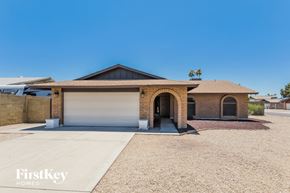 Phoenix house for rent - A house with a garage and a driveway in front of it.