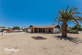 Phoenix house for rent - A palm tree stands in front of a house with a sign that says "FirstKey Homes.".