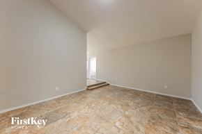 Phoenix house for rent - A spacious room with a stone floor and white walls.