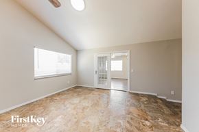 Phoenix house for rent - A room with a slanted ceiling and a doorway leading to another room.