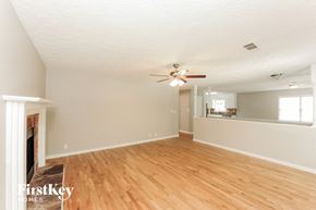 Sugar Hill house for rent - A room with wooden floors and a ceiling fan.