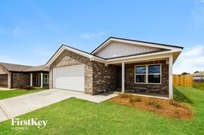 Tuscaloosa house for rent - a home with a white garage door and a brick house