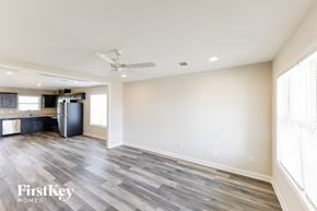 Tuscaloosa house for rent - an empty living room and kitchen with wood flooring
