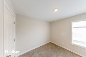 Tuscaloosa house for rent - a bedroom with white walls and a window and carpet