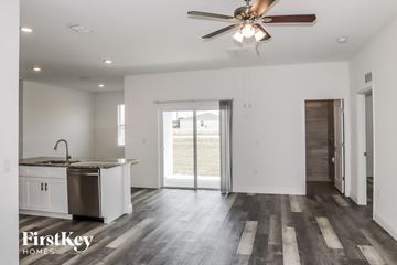 Poinciana house for rent - A spacious kitchen with a sink, stove, and a ceiling fan.