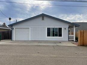 Orcutt house for rent - A grey house with a white garage door.