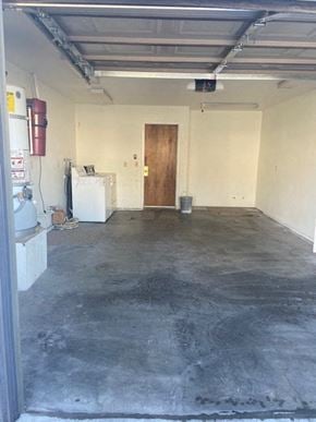 Santa Maria house for rent - A room with a door and a white refrigerator.