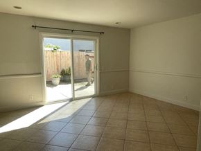 Santa Maria house for rent - A man is standing in a room with a sliding glass door.
