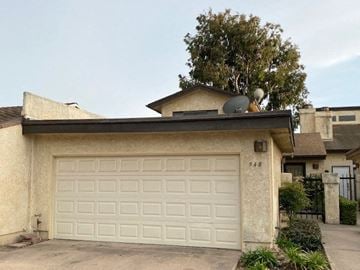 Santa Maria house for rent - A house with a white garage door and the number 948 on it.