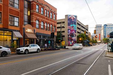 Memphis apartment for rent - a city street with cars and buildings and a mural on the side