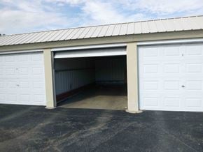 Clinton Township house for rent - A large garage door is open, revealing a spacious interior.