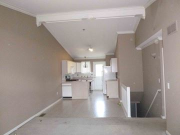 Clinton Township house for rent - A kitchen with white appliances and a white refrigerator.