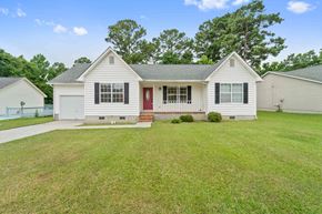 Jacksonville house for rent - A white house with a red door and a grey roof.