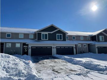 Hudson house for rent - a house with a driveway covered in snow