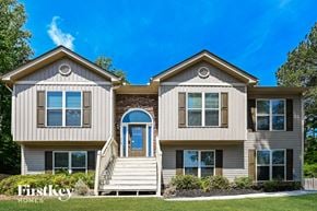 Loganville house for rent - a beige and brown house with a blue sky in the background