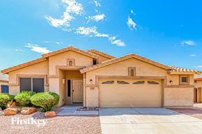 Surprise house for rent - A beige house with a garage door and a driveway.