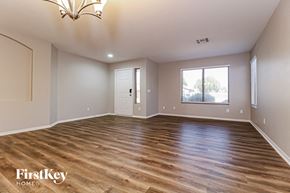 Surprise house for rent - A room with wooden flooring and a chandelier.