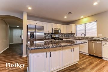 Surprise house for rent - A kitchen with a refrigerator, microwave, and oven.