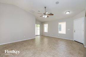 San Tan Valley house for rent - A spacious room with a ceiling fan and tiled flooring.