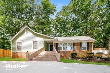 Charlotte house for rent - a white and brick house with stairs in front