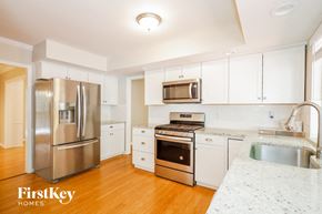 Charlotte house for rent - a kitchen with stainless steel appliances and white cabinets