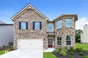 Mcdonough house for rent - a brick house with a white garage door