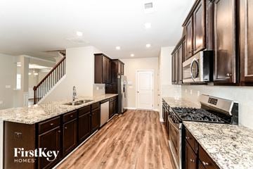 Mcdonough house for rent - a kitchen with granite counter tops and wood floors