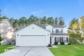 Summerville house for rent - a white house with a garage door and a lawn