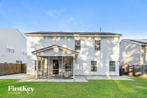 Summerville house for rent - the exterior of a white house with a glass porch