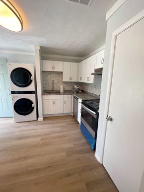 Riverdale apartment for rent - a small kitchen with a washer and dryer in it